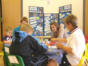 p62000362 Staff from Sure Start providing an activity for children at the All Saints Church Summer Fair